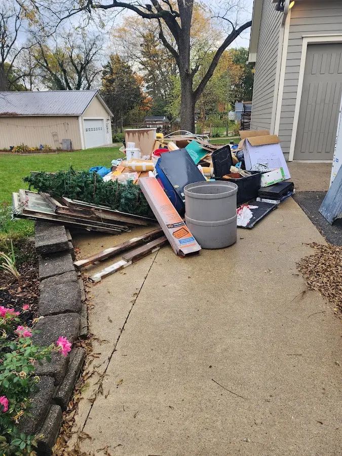 Dumpster being loaded with debris for Roofing Dumpster Rental in Poteau